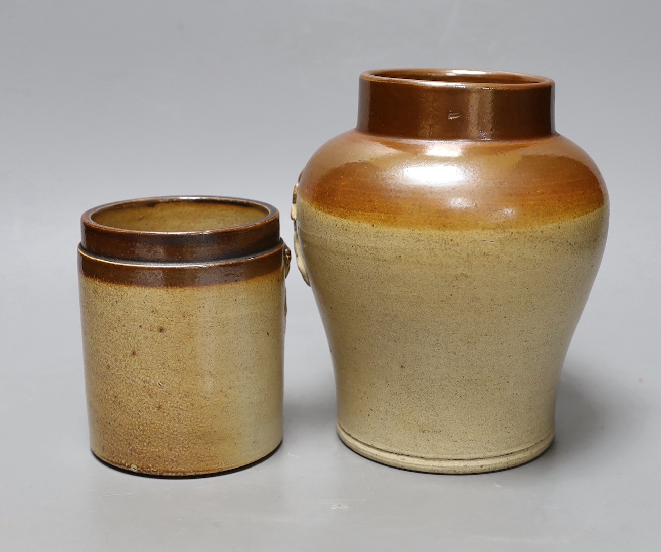 Two 19th century salt glazed stoneware storage jars, with Royal coat of arms sprigging, Tallest 18cm high